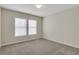 Carpeted bedroom with neutral paint, two windows, and ample space at 1300 Hopkins Dr, Decatur, GA 30033