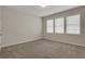 Neutral bedroom featuring carpet floors, windows and light walls at 1300 Hopkins Dr, Decatur, GA 30033