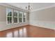 Bright dining room featuring hardwood floors, large windows, decorative molding, and a modern chandelier at 1300 Hopkins Dr, Decatur, GA 30033