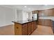 Spacious kitchen featuring dark granite countertops, an island with a sink, and stainless appliances at 1300 Hopkins Dr, Decatur, GA 30033