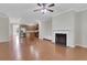 Open-concept living room featuring hardwood floors, a fireplace, and a view of the kitchen at 1300 Hopkins Dr, Decatur, GA 30033