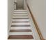 Bright staircase with hardwood treads, white risers, and a classic wooden handrail at 1300 Hopkins Dr, Decatur, GA 30033