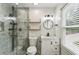 Bathroom features a glass shower, floating shelves, and vanity at 232 Apple Branch Dr, Woodstock, GA 30188