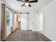 Bright bedroom featuring a barn door closet and plush carpeting at 232 Apple Branch Dr, Woodstock, GA 30188