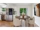 Bright dining room features stainless appliances, recessed lighting, and door to yard at 232 Apple Branch Dr, Woodstock, GA 30188