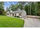 Stylish renovated cottage with concrete driveway, wooden shutters, and lush lawn at 232 Apple Branch Dr, Woodstock, GA 30188