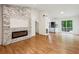 Bright, open living space with modern electric fireplace and wood-look floors at 232 Apple Branch Dr, Woodstock, GA 30188
