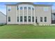 Exterior of the home with a patio and lush green lawn in the backyard at 411 Ridgeway Ln, Canton, GA 30114