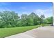 A view of the beautiful lawn and landscape in the backyard with lush green trees at 411 Ridgeway Ln, Canton, GA 30114