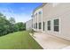 Exterior of the home with a patio and lush green lawn and trees in the backyard at 411 Ridgeway Ln, Canton, GA 30114