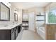 A bright bathroom has a bathtub, a glass shower, a double sink vanity, and a window at 411 Ridgeway Ln, Canton, GA 30114