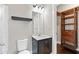 Clean bathroom featuring a single vanity, a large mirror, and an open closet at 411 Ridgeway Ln, Canton, GA 30114