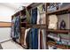 A walk-in closet has custom wood shelving and rods for plenty of storage with a window at 411 Ridgeway Ln, Canton, GA 30114