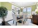 Inviting dining room with large window, hardwood floors, and chandelier at 411 Ridgeway Ln, Canton, GA 30114