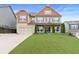 Charming two-story home featuring a manicured lawn, a two-car garage and inviting front porch at 411 Ridgeway Ln, Canton, GA 30114