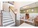 Foyer featuring staircase, hardwood floors, and a cozy sitting room with stylish decor at 411 Ridgeway Ln, Canton, GA 30114