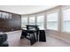 A game area has a wood accent wall, lots of natural light, and a dark wood table and benches at 411 Ridgeway Ln, Canton, GA 30114