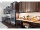 Kitchen details with stainless steel appliances, dark wood cabinetry, granite countertops, and tile backsplash at 411 Ridgeway Ln, Canton, GA 30114