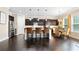 Modern kitchen with dark cabinetry, granite countertops, stainless steel appliances, and island seating at 411 Ridgeway Ln, Canton, GA 30114