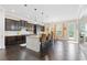 Open kitchen with dark cabinets, a large island, stainless appliances, and a dining nook with bright windows at 411 Ridgeway Ln, Canton, GA 30114