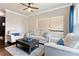 Comfortable living room with plush seating, hardwood floors, and lots of natural light at 411 Ridgeway Ln, Canton, GA 30114