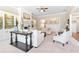 The formal living room has a fire place, large windows, and white sofas and chairs at 411 Ridgeway Ln, Canton, GA 30114