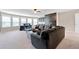 A living room has a large sectional sofa, a bar, a mounted TV, and lots of windows at 411 Ridgeway Ln, Canton, GA 30114