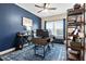 This beautiful home office has a ceiling fan and a large window for plenty of natural light at 411 Ridgeway Ln, Canton, GA 30114