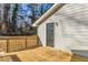 A back porch with wooden floors, a black door, and light gray vinyl siding at 204 Elm St, Palmetto, GA 30268