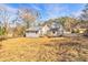 A spacious backyard showing the home's rear elevation and large, dry lawn at 204 Elm St, Palmetto, GA 30268