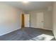 Bedroom with neutral walls and carpeting with an open closet at 204 Elm St, Palmetto, GA 30268