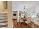 Bright dining room with hardwood floors, modern chandelier, and open layout adjoining the living room at 204 Elm St, Palmetto, GA 30268