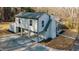 Inviting two-story home featuring light gray siding, brick chimney, and a spacious driveway, captured from an aerial perspective at 204 Elm St, Palmetto, GA 30268