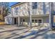 Inviting two-story home featuring light gray siding, brick accents, and a spacious driveway nestled among mature trees at 204 Elm St, Palmetto, GA 30268