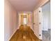 Hallway with hardwood floors and multiple access points leading to other rooms in the house at 204 Elm St, Palmetto, GA 30268
