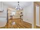 Modern kitchen with stainless steel appliances, white cabinets, granite countertops, and a stylish light fixture at 204 Elm St, Palmetto, GA 30268