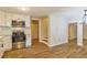 Modern kitchen with stainless steel appliances, white cabinets, granite countertops and hardwood flooring at 204 Elm St, Palmetto, GA 30268