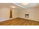 Open living area featuring a painted brick fireplace, hardwood floors and access to the front entryway at 204 Elm St, Palmetto, GA 30268