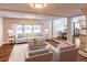 Bright living room with hardwood floors, neutral-toned furniture, large windows, and an open layout at 204 Elm St, Palmetto, GA 30268