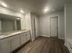 Bright bathroom featuring double sinks with white cabinets, and a large mirror and a separate shower and bath at 35 Yellow Brick Way, Covington, GA 30014