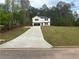 Lovely two-story home with a freshly poured concrete driveway and a large, manicured front lawn at 35 Yellow Brick Way, Covington, GA 30014