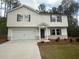 Charming two-story home with white siding, black shutters, and a spacious two-car garage at 35 Yellow Brick Way, Covington, GA 30014