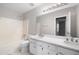 Bathroom featuring double vanity sinks, a bathtub, and large mirror at 6275 Cheatham Lake Nw Dr, Acworth, GA 30101