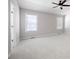 Spacious bedroom with a ceiling fan, plush carpet, neutral walls, and a window with blinds at 6275 Cheatham Lake Nw Dr, Acworth, GA 30101
