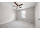 Neutral bedroom with a ceiling fan, carpet floors, and a window at 6275 Cheatham Lake Nw Dr, Acworth, GA 30101