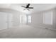 Spacious bedroom with a ceiling fan, plush carpet, neutral walls, and two windows with blinds at 6275 Cheatham Lake Nw Dr, Acworth, GA 30101