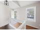 Entryway with wood floors, white railings, and stairs leading to front door at 6275 Cheatham Lake Nw Dr, Acworth, GA 30101