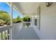 Front porch featuring gray wood flooring, white columns, and wood siding at 6275 Cheatham Lake Nw Dr, Acworth, GA 30101