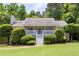 Charming single Gathering home featuring a landscaped yard, front porch with white stairs, and trimmed bushes at 6275 Cheatham Lake Nw Dr, Acworth, GA 30101