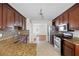 Bright kitchen features tile floors, granite countertops, stainless steel appliances, and stylish backsplash at 6275 Cheatham Lake Nw Dr, Acworth, GA 30101